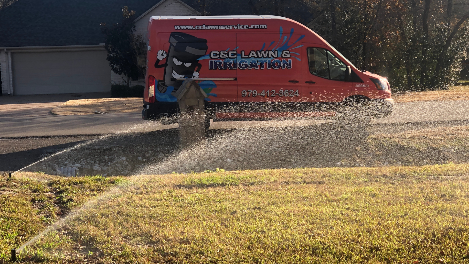 C&C Lawn and Irrigation service truck on a Brazos Valley property ready to perform a summer sprinkler system setup