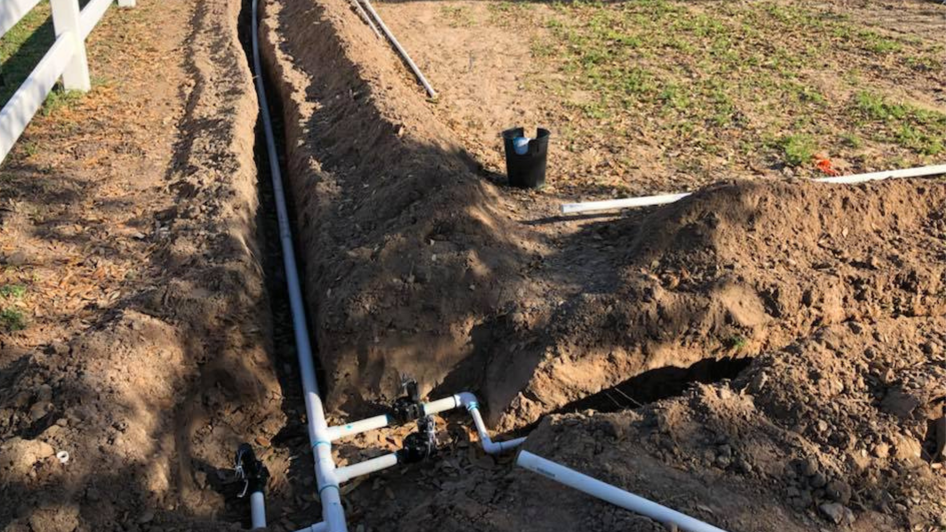 C&C Lawn & Irrigation crew installing and adjusting a residential sprinkler system in Bryan College Station Texas, the kind of inspection work that resolves dry spots from misaligned heads, pressure problems, and coverage gaps